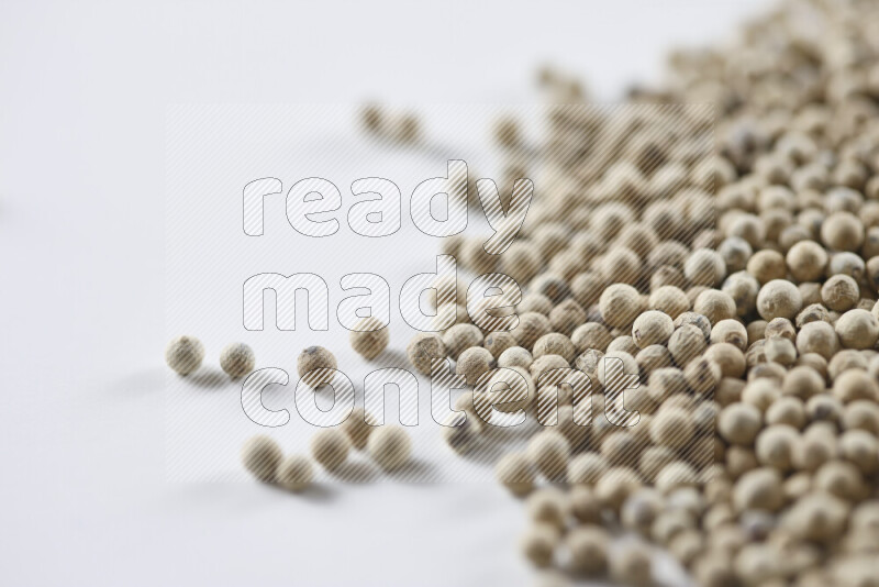 White pepper beads on white background