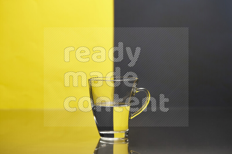 The image features a clear glassware filled with water, set against yellow and black background