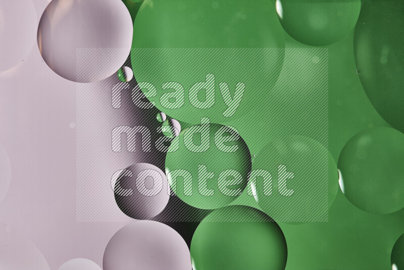 Close-ups of abstract oil bubbles on water surface in shades of white and green