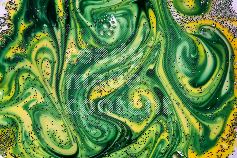A close-up of sparkling green glitter scattered on swirling yellow and green background