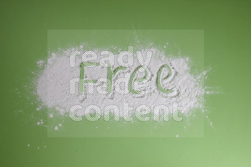 A word written with white powder on green background