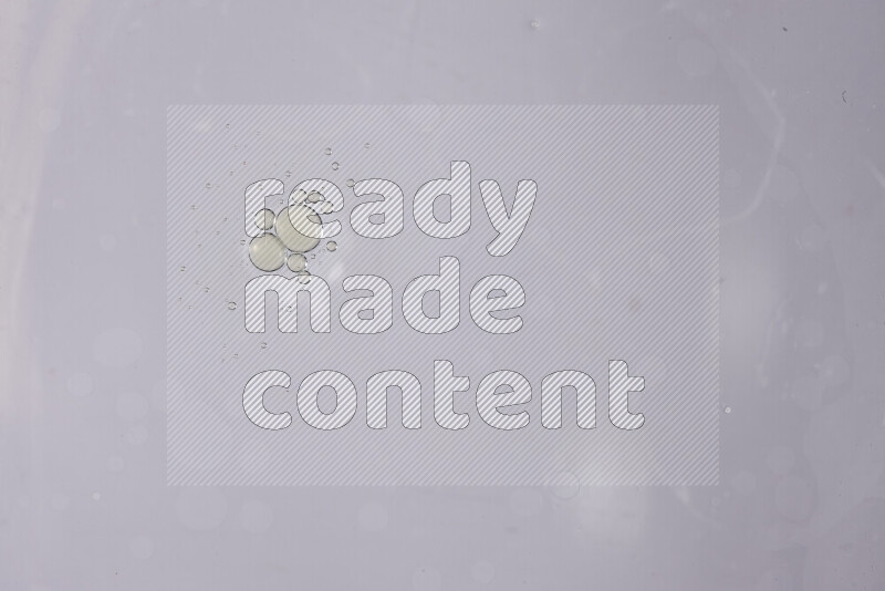 Abstract oil droplets in a water surface on white background