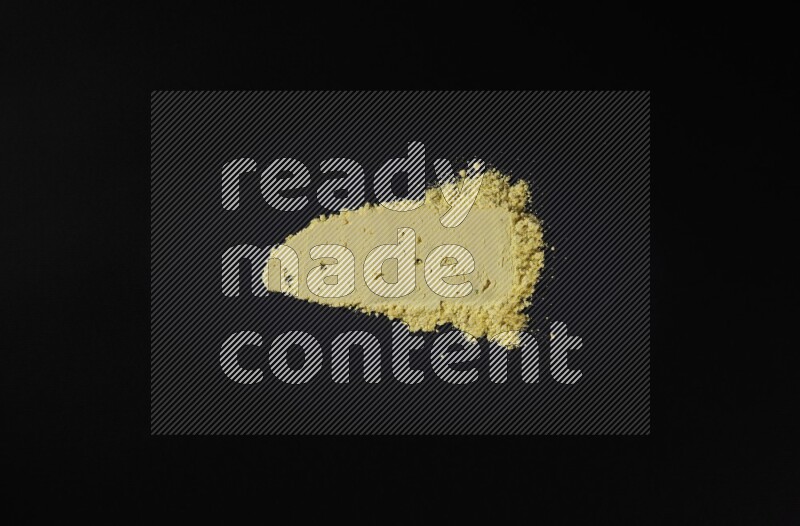 Yellow powder smears on black background