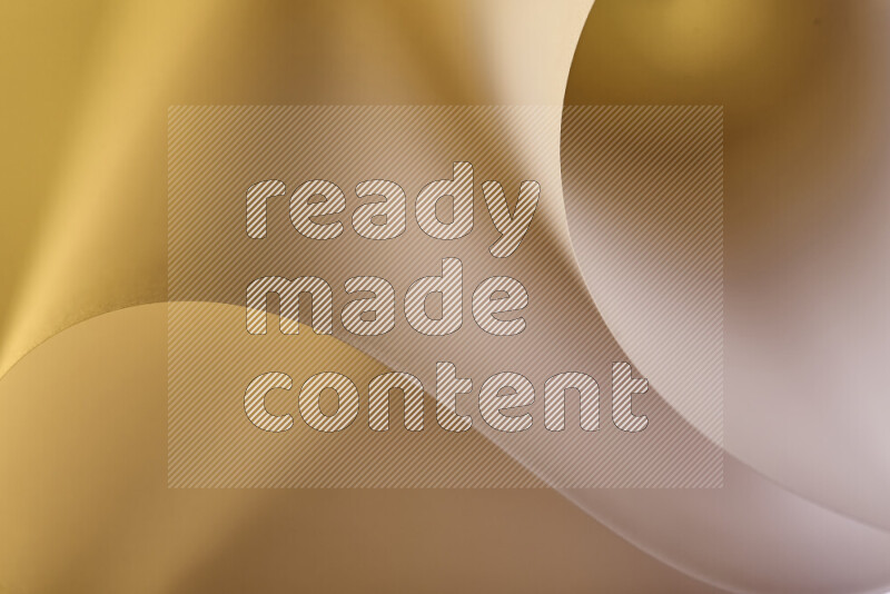 An abstract art piece displaying smooth curves in gold gradients created by colored light