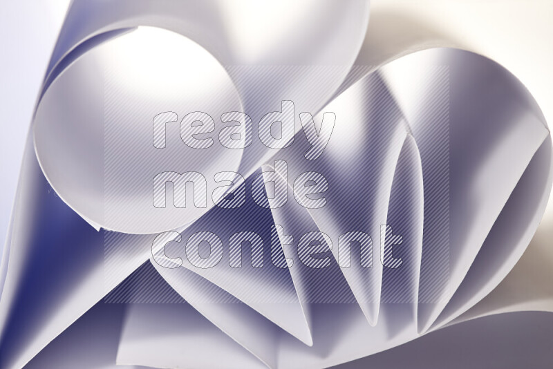 An artistic display of paper folds creating a harmonious blend of geometric shapes, highlighted by soft lighting in grey