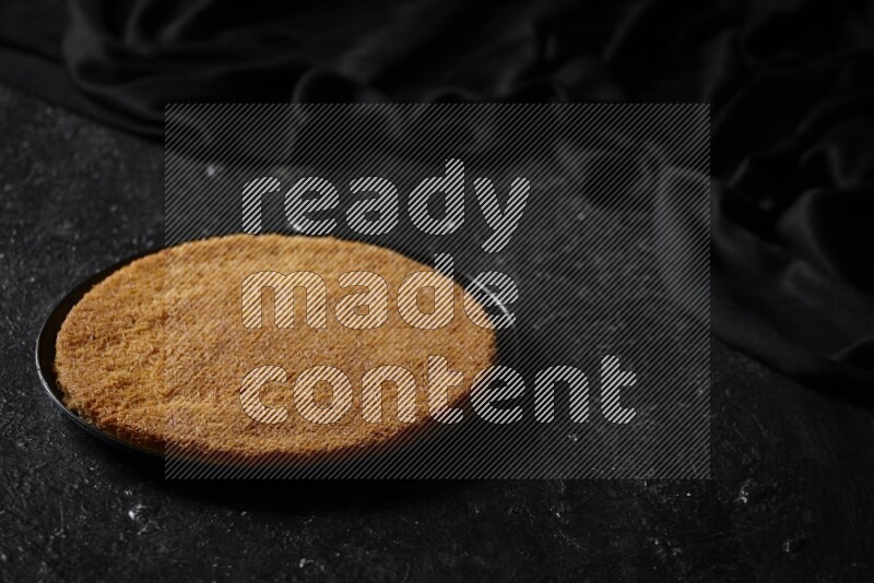 Konafa in different plates in a dark setup