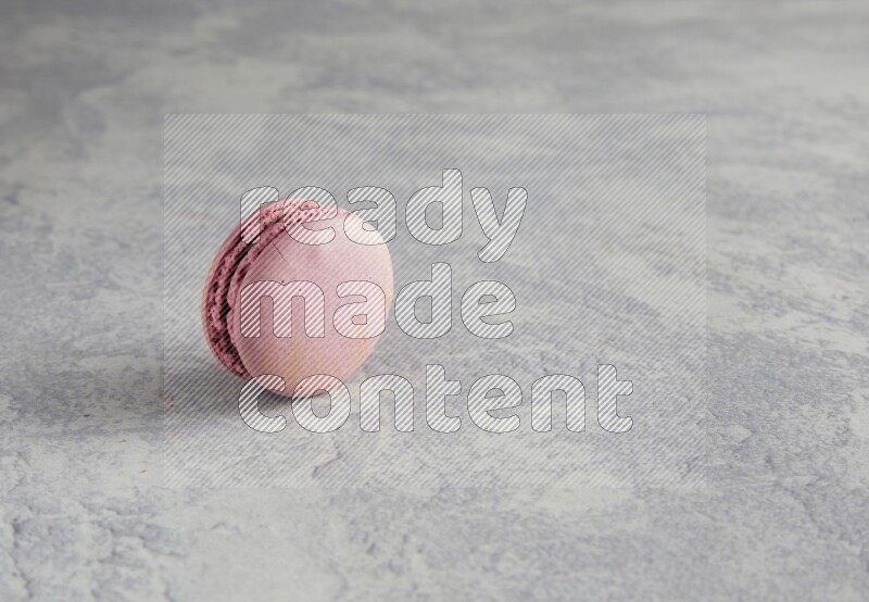 45º Shot of Purple Strawberry macaron on white  marble background