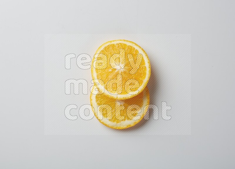 Two orange slices on white background