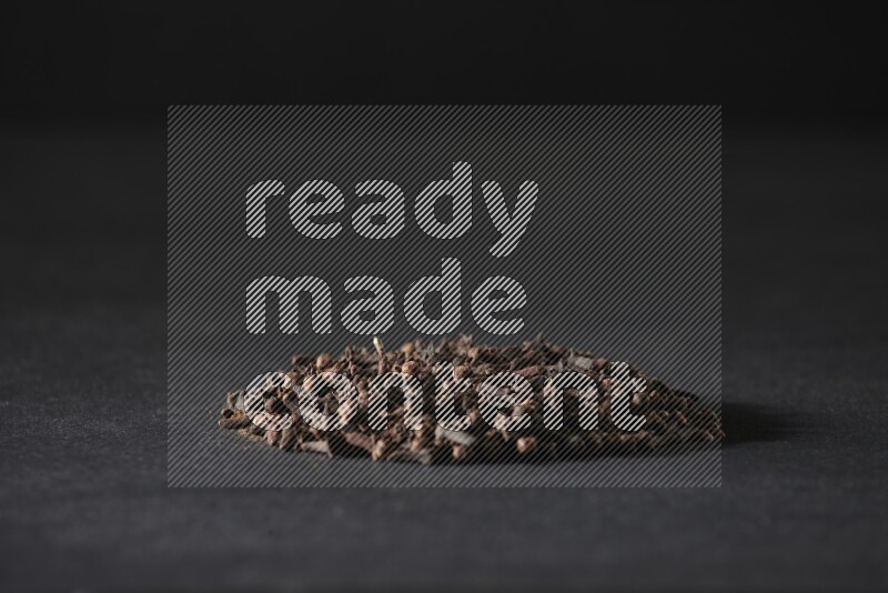 Cloves in a circle shape on a black flooring