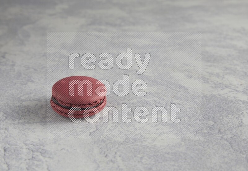 45º Shot of Red Cherry macaron on white  marble background