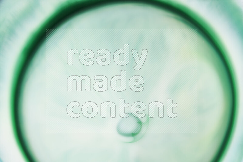 A close-up of abstract swirling patterns in green gradients