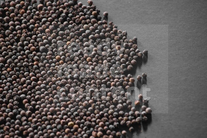 Black pepper on a black flooring
