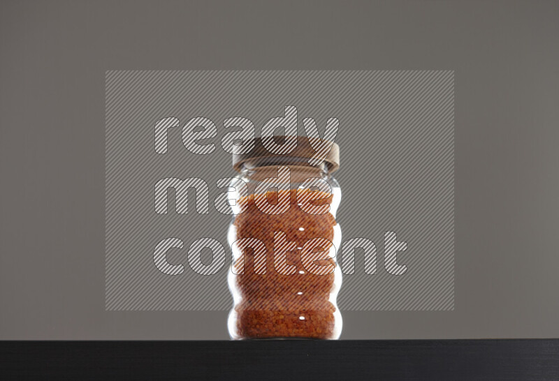Lentils in a glass jar on black background
