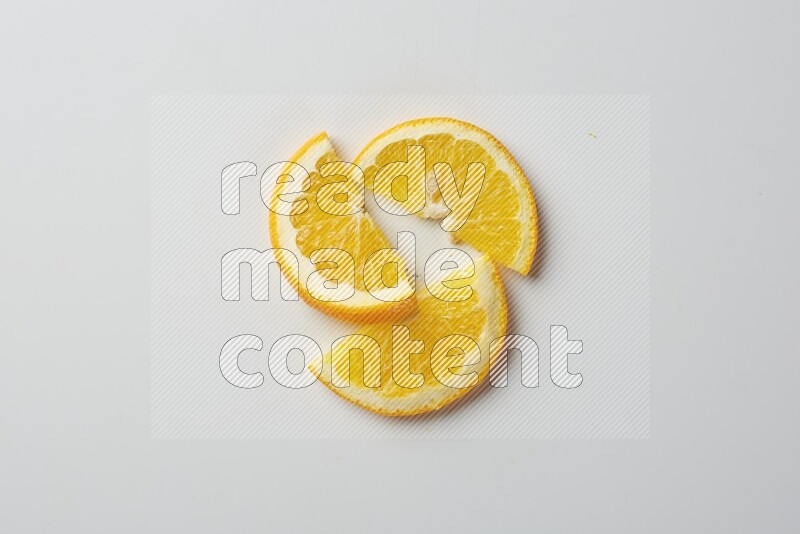 Three halves of an orange slices on white background