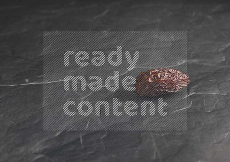 one madjoul date on a black textured background