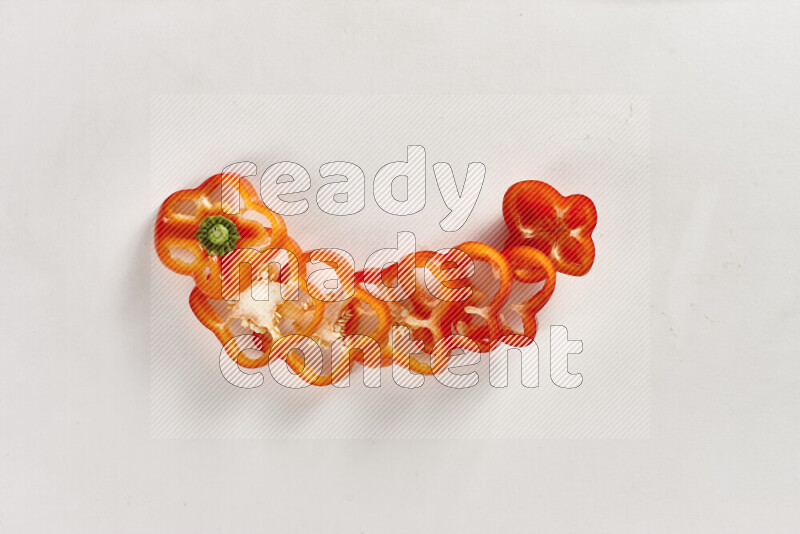 Red bell pepper slices on white background