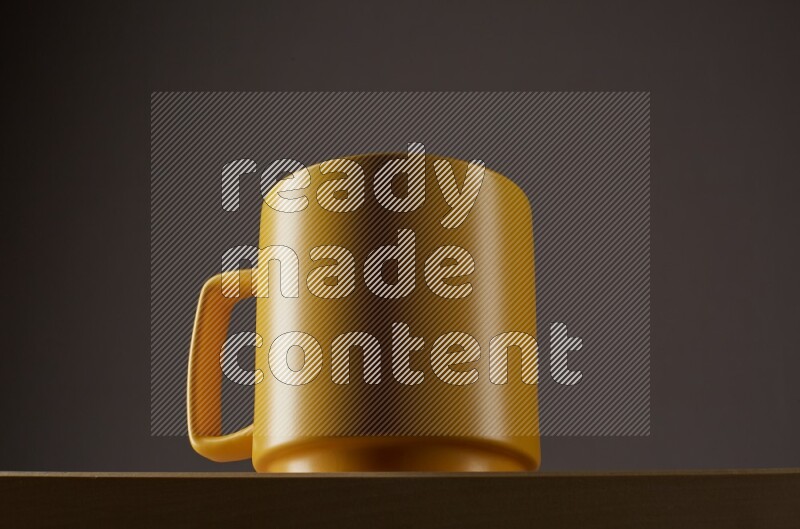 Low angle shot of a yellow cup on grey background