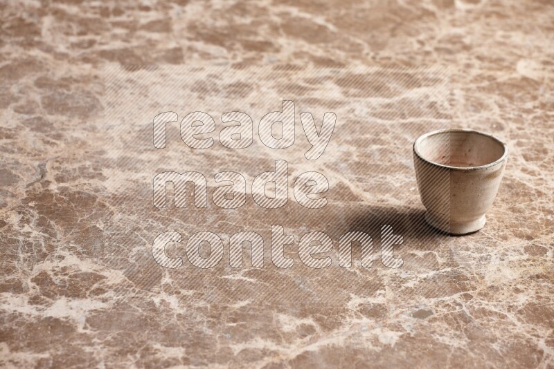 Pottery Cup on Beige Marble Flooring
