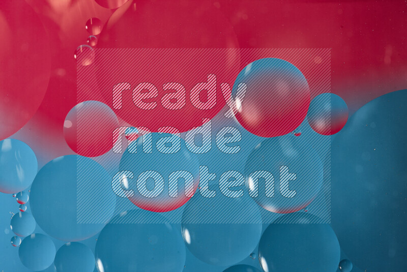 Close-ups of abstract oil bubbles on water surface in shades of blue and pink