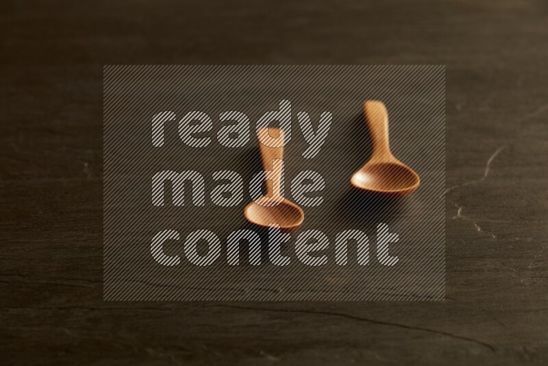 wooden spoon on black slate background