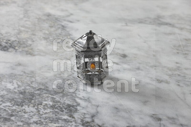 A lantern placed on a grey marble background