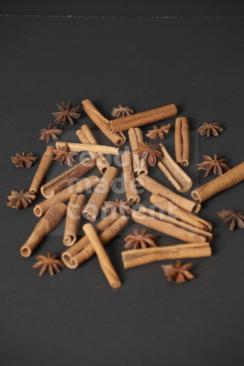 Cinnamon sticks and star anise on black background