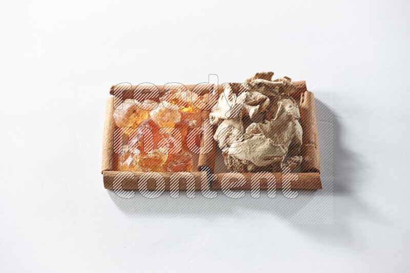 2 squares of cinnamon sticks full of dried ginger and gum arabic on white flooring