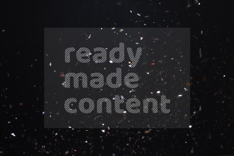 Falling multicolored confetti on black background
