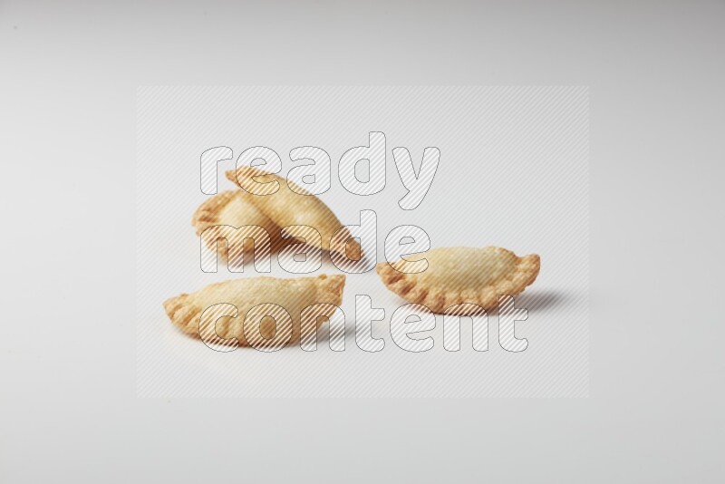 Four fried sambosas on a white background