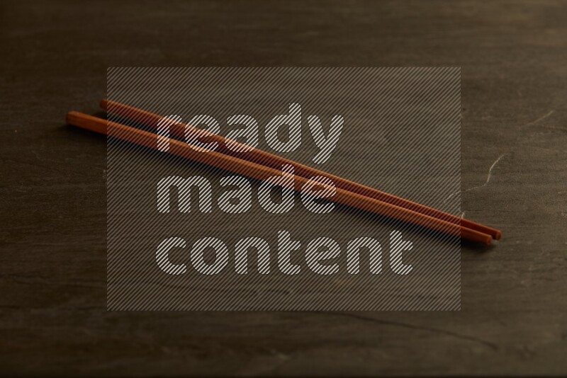 wooden chopsticks on black slate background