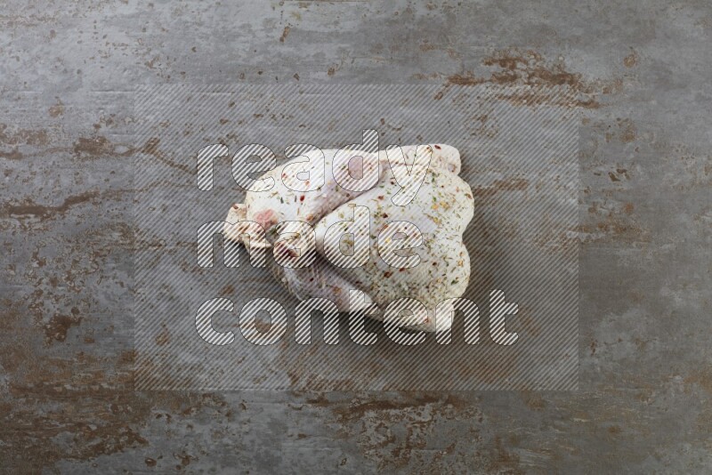 whole raw chicken  direct on a rustic grey background