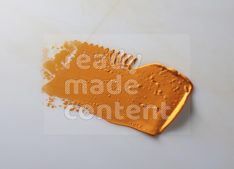 An orange straight painting knife stroke on white background