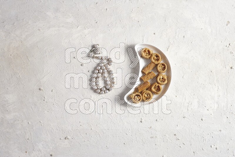 konafa in a pottery plate with sebha in a light setup