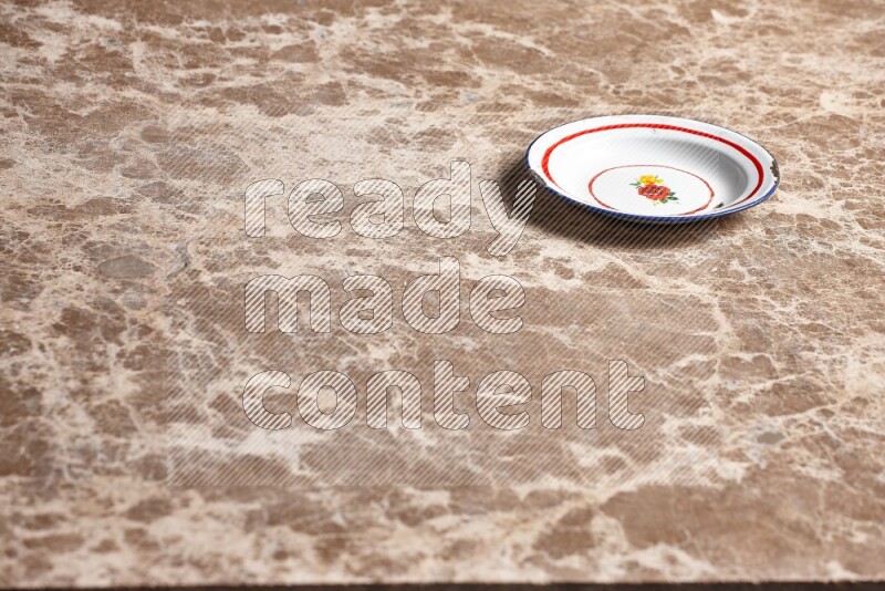 A vintage metal plate on beige marble background