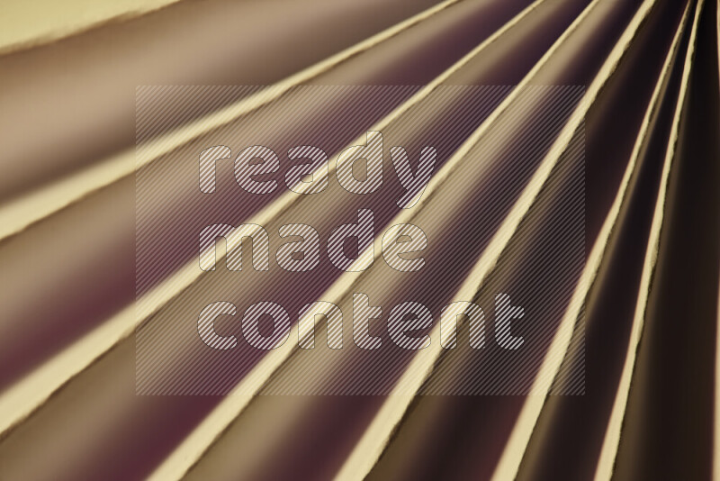 An image presenting an abstract paper pattern of lines in red and gold tones