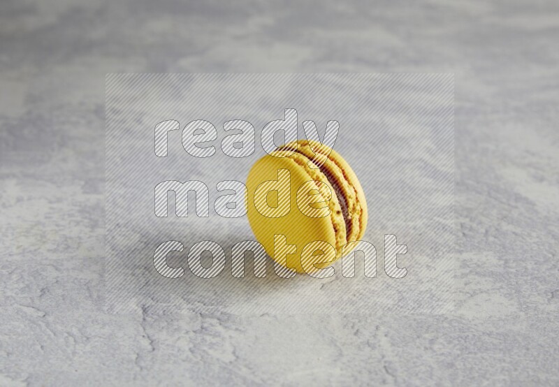 45º Shot of Yellow Lemon macaron on white  marble background