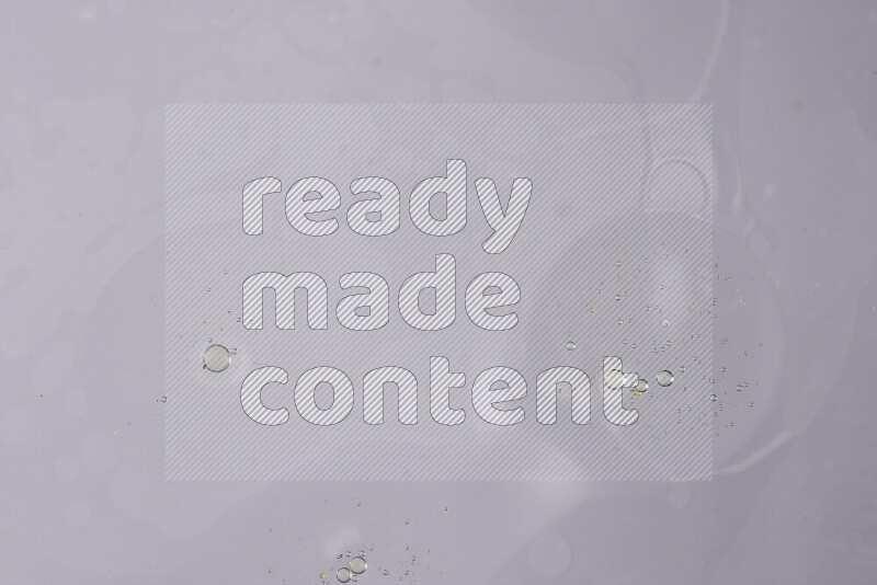 Abstract oil droplets in a water surface on white background