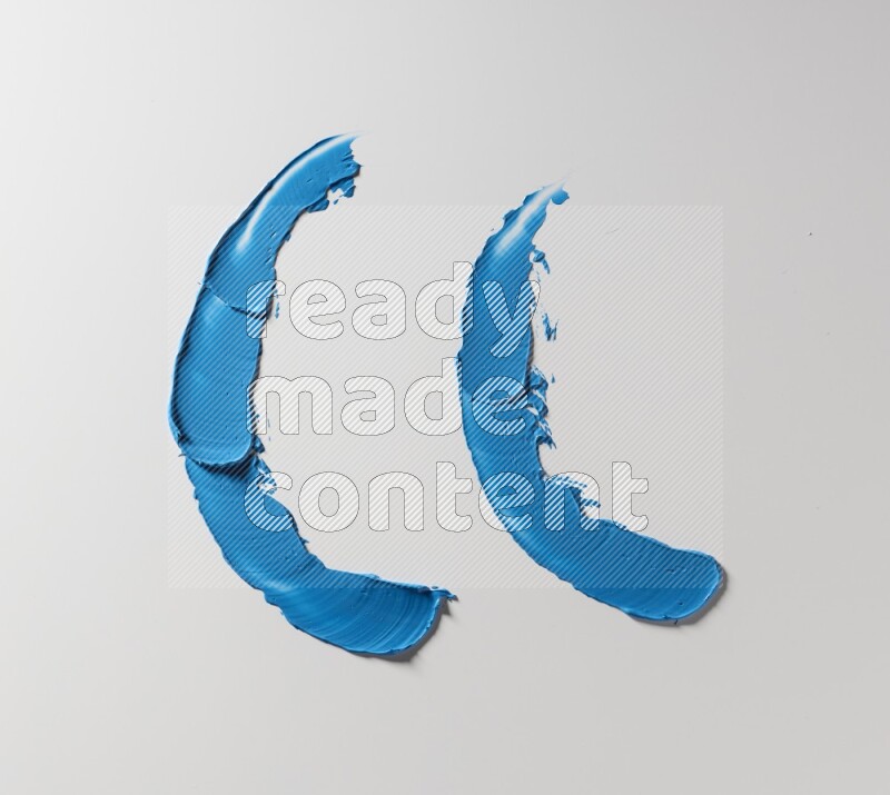 Blue curved painting knife strokes on white background