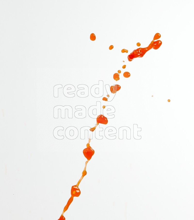 Orange liquid splash and drops on white background