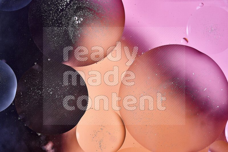 Close-ups of abstract oil bubbles on water surface in shades of blue, orange and pink