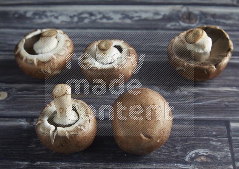 45 degree Cremini  mushrooms on a textured grey background