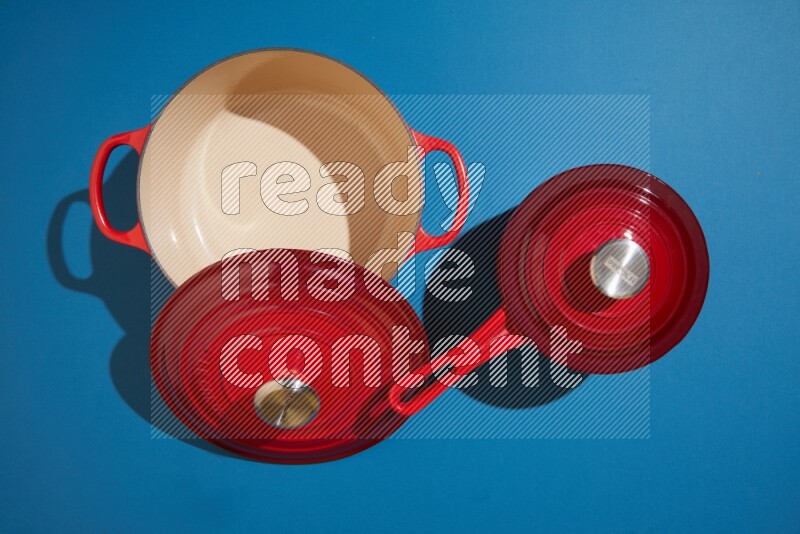 red and white pan and pot on blue background