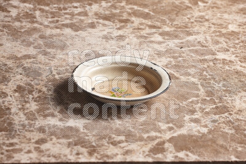 A vintage metal plate on beige marble background