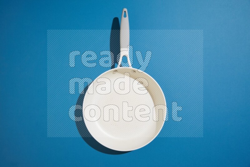 white pan on blue background