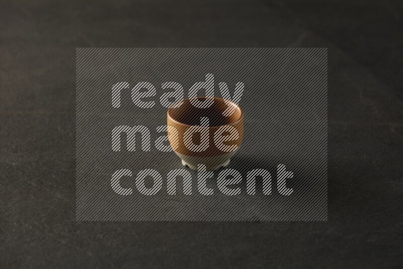 multi color round sauce bowl on grey textured countertop