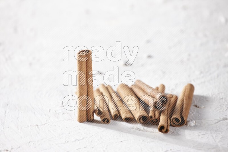 Cinnamon sticks on a textured white background