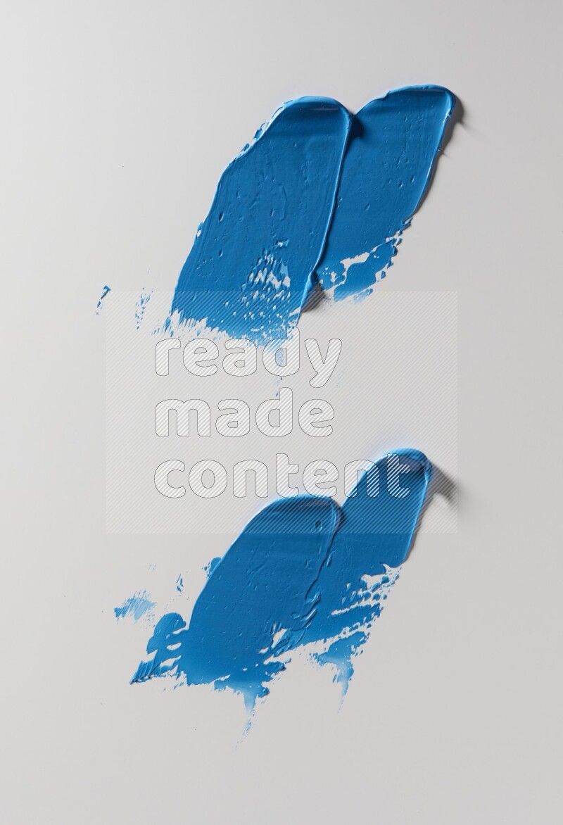Blue painting knife strokes on white background