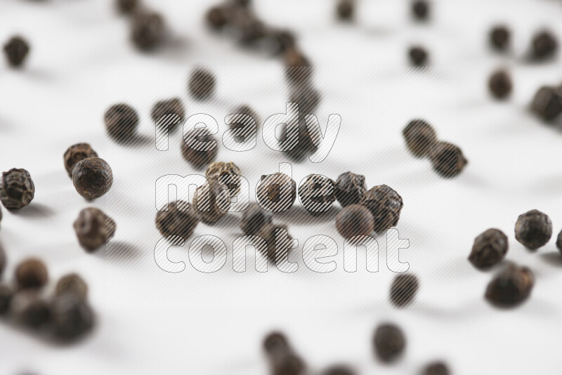 Black pepper beads on white background
