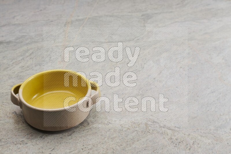 A multicolored pottery bowl on grey marble background