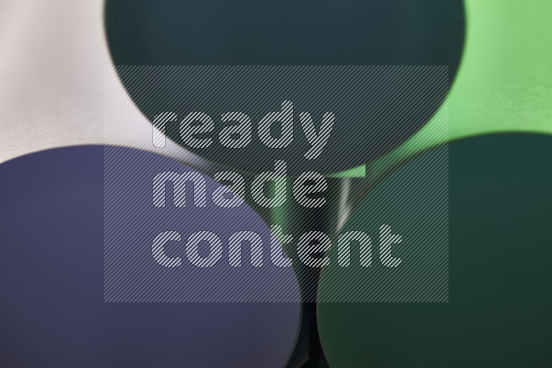 The image shows an abstract paper art with circular shapes in varying shades of green